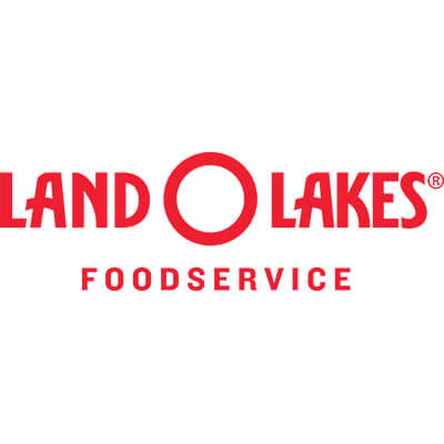 Happy kitchen staff member with Land O Lakes® Performance Cheese Sauces